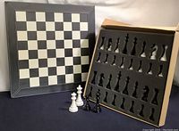Full view of leather chessboard and foam-lined storage box with chess pieces, showing size and storage layout