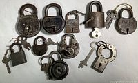 Overview of all ten padlocks laid out with their keys