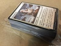 Stack of over 95 Magic the Gathering cards visible with the front card showing "Makindi Ox" with fantasy artwork.