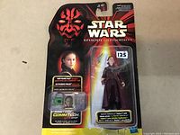 Clear photo of sealed Star Wars Episode I Queen Amidala figure with CommTech chip carded on blister packaging featuring Darth Maul graphic.