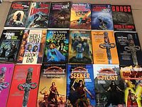 Photo of 12 fantasy novels laid out with covers visible featuring various titles and authors.