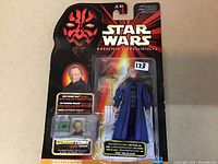 Front view of sealed Senator Palpatine Star Wars Episode I action figure on card, showing figure, staff, communicator chip, and packaging artwork.