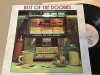 Photo of Best of The Doobies vinyl LP album cover and visible vinyl record.