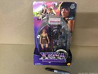 Full front view of Gabrielle Xena Warrior Princess action figure sealed on original card with associated accessories and artwork.