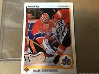 Close-up front image of the Patrick Roy hockey card showing the autograph and game action.