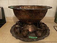 Full set: punch bowl on pedestal, round tray, ten cups arranged around base
