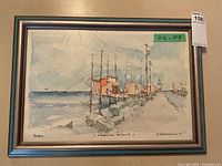 Full view of the framed art print depicting the coastal scene in Pescara, Italy, showing boats, buildings and a pier under a cloudy sky.