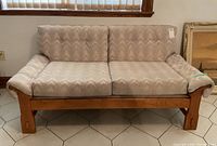 Front view of the Mid-Century Modern love seat sofa showing solid wood frame and patterned cushions.