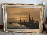 Full view of vintage framed coastal scene painting with boats at dusk/dawn.