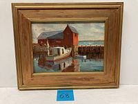 Framed oil painting of red boathouse with boats and water reflections
