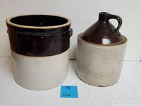 Photo of two antique American made stoneware items: a large crock and a jug. Both are brown and beige with glazed finishes, showing light wear and some nicks.