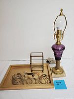 Full view of the lamp, jewelry arranged on a brass tray, and miniature brass curio box