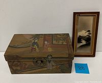 Photo showing the dresser box with folk art and framed Japanese painting side by side.