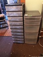 Photo of two large plastic stackable storage bin units side by side, showing multiple drawers and overall size.