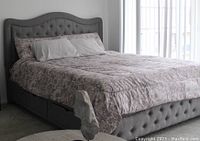 Grey upholstered king size bed frame showing headboard, footboard, side rails, and under-bed drawers