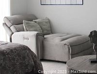 Gray electric reclining chaise lounge chair with two throw pillows