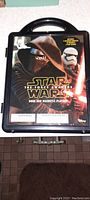 Front view of the Star Wars The Force Awakens magnetic playset closed inside original black plastic carrying case featuring Kylo Ren and Stormtrooper artwork.