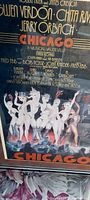 Close-up photo of framed vintage Chicago theatre poster showing illustrated dancers and text details