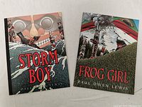 Front covers of the two books Storm Boy and Frog Girl by Paul Owen Lewis, showing illustrated Indigenous style artwork and titles.