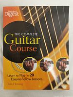 Front cover of the guitar instruction book showing title, author, and cover art featuring a guitar and chords.