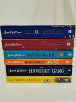 Stack of six David Walliams novels showing colorful spines and titles.