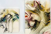 Two abstract art pieces shown together on a white surface. Smaller piece on left with green and blue accents, larger piece on right with red and gold tones.