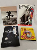 Michael Jackson, David Bowie, and Jimi Hendrix books with Jimi Hendrix wall art visible