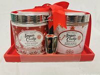 Front view of Purely Panache Sugar Cookie Body Butter and Body Scrub set with red tray and tied with red ribbon.