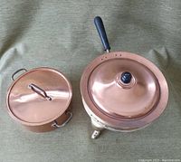 Copper chafing dish and pot side by side, showing lids and handles