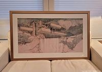 Framed Fallingwater print centered on couch