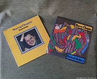 Photo of album covers for Harry Chapin Heads & Tales (yellow cover) and Portrait Gallery (colorful abstract artwork)