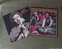 Two vinyl record covers: Gordon Lightfoot black and white portrait and Kenny Rogers foldout cover with gambling scene artwork.