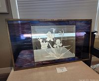 Full view of the brass framed stained glass panel with purple border and central etched floral glass insert