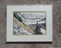Front view of the framed Rocky Mountain watercolour painting showing the landscape artwork, matting, and aluminum frame.