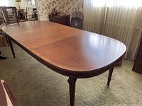 Full view of oval dining table set up in room
