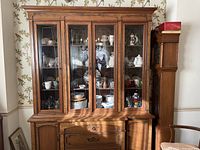 Front view of the Ethan Allen hutch filled with display items such as dishes and glassware.