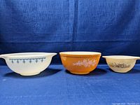 Front view of all three Pyrex mixing bowls showing size and pattern differences