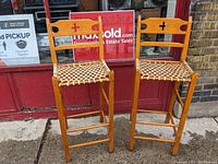 Front view of both maple rawhide chairs side by side