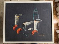 Framed mid century still life surrealist painting on dark background with cylinders and orange spheres by Danish artist Cay-Skot, signed in lower right corner.