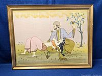 Full view of the framed silk painting showing a man and woman in a nature scene.