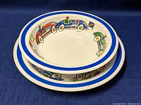 Side and front view of a stacked race car china shallow bowl and flat plate, with colorful vintage race car illustrations and blue rims.