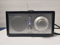 Front view of the Tivoli Audio Model One radio showing speaker, knobs, and indicator lights.