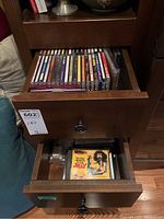 Two drawers filled with approximately 40 music CDs in jewel cases from various artists and albums, including one titled 'It's The Long Way To The Top' by Mantis.