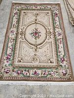 Full view of the hand knotted Aubusson style carpet laid flat to show design and colors.