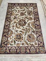 Full view of rug laid flat on floor showing overall pattern and condition