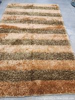 Full view of the modern hand knotted carpet showing the striped color pattern and size.