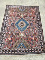 Full view of carpet laid flat on concrete floor