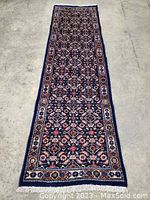 Full view of runner rug laid flat on concrete floor showing overall pattern and size