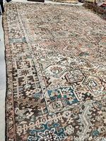 Full view of rug on floor, showing overall pattern and condition