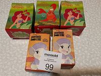 Five McDonald's toys in original bent boxes, featuring Disney The Little Mermaid and Rescue Dawn characters.